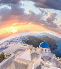Old Town of Thira on the island Santorini, famous church against colorful sunset in Greece
