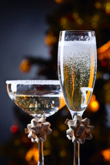 Two glasses with champagne and Christmas ornaments
