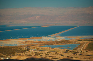 Top view from the Judean Desert on the places salt mining . The Dead sea.