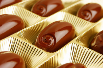 chocolate candies in a gold gift box