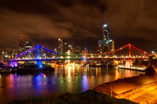 colourful bridge lights against night city