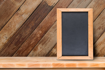 Blackboard  with on wooden table with blurred bokeh background.