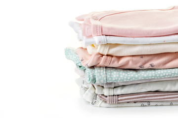 Pile of baby clothes isolated on white