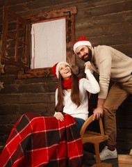 Young couple in holiday home in Christmas celebrating together
