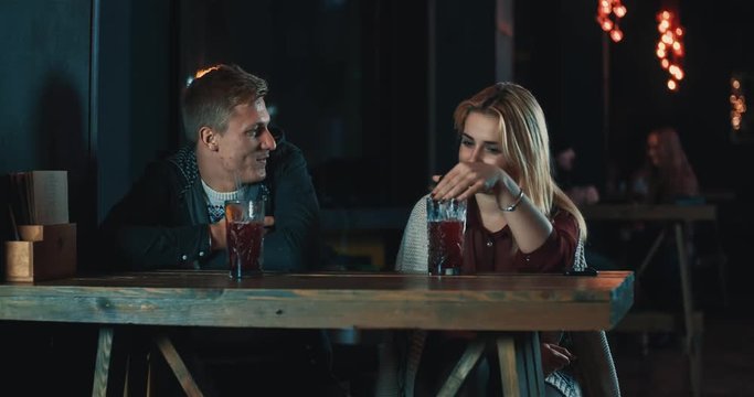 Couple in date talking at bar 4k video. Young woman and man in cafe with beverage flirt, smiling