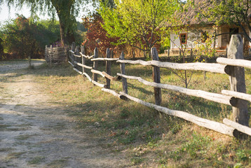 The fence in the village along the road