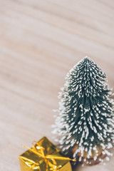christmas tree and gift on wood.