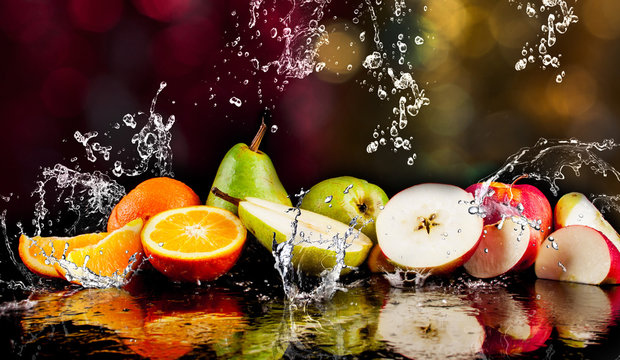 Pears, apples, orange  fruits and Splashing water