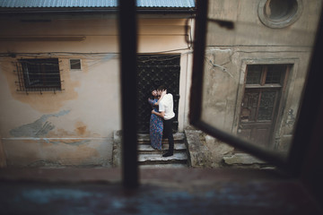 Fototapeta na wymiar Man is kissing his woman next to the door