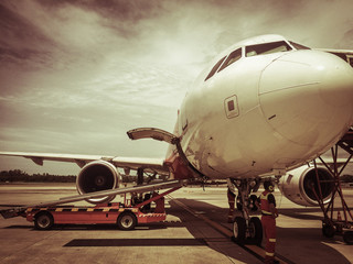 Obraz premium Loading bag on the plane in airport, selective focus , vintage p