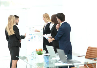 Colleagues asking a question to a businesswoman during a present