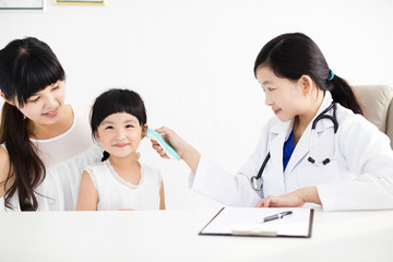 female doctor Taking temperature using in ear thermometer