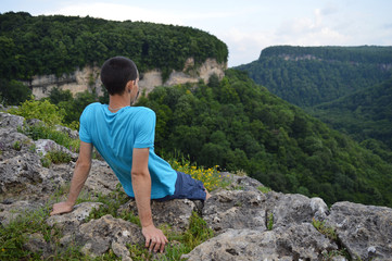 Naklejka na ściany i meble Tourist looking at mountains near the ruins