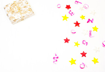 Gift with decor from stars, confetti on a white background.