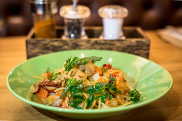 Spicy spaghetti on wooden table
