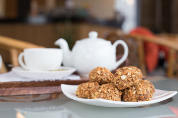 walnut balls, confectionery treats on the table with a cup of tea and teapot