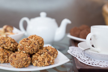 walnut balls, confectionery treats on the table with a cup of tea and teapot