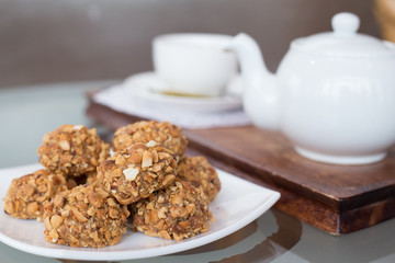 walnut balls, confectionery treats on the table with a cup of tea and teapot