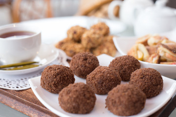 chocolate balls on the table close-up, different food, apple and walnut