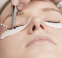 Traditional eyelash extensions. Selective focus. Toned. Makeup close-up.
