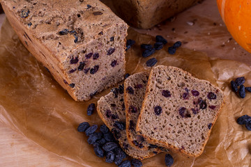 a loaf of bread on the background of cutting boards and other bread and pumpkin,