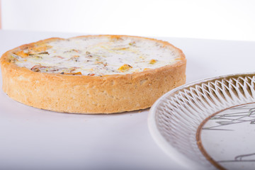 vegetable pie on a plate, white background, studio photo