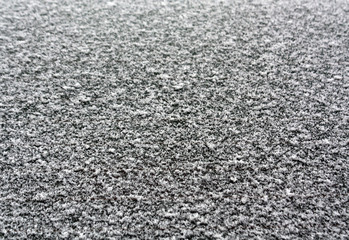 Snow and frost on car glass shooted with blur effect.