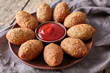 Kibbeh traditional middle eastern oriental restaurant lamb meat stuffed and bulgur kofta spicy meatball croquettes food on vintage wooden table background