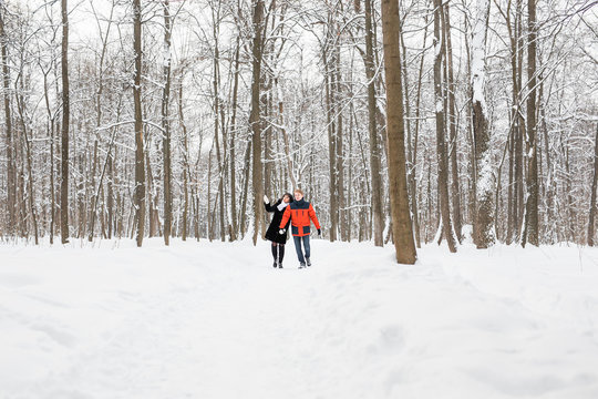 Young couple in love holding hands outdoor in winter