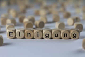 Einigung - Holzwürfel mit Buchstaben
