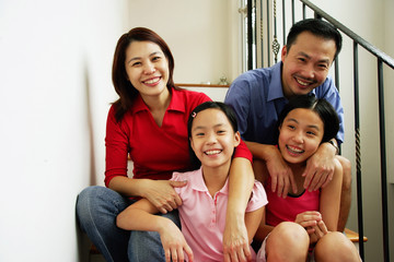 Family with two girls, smiling at camera