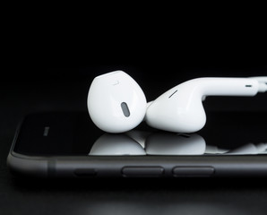 close-up headphone on phone black background
