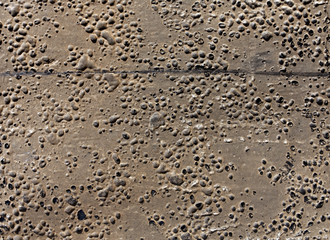 Grungy rubber surface with bubbles and scratches.