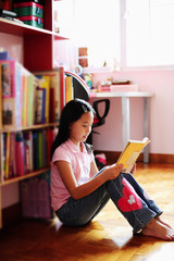 Girl sitting, reading book