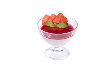 Sweet dessert of strawberry cream berry jelly with mint leaves in a glass