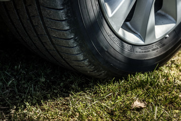 car wheel closeup on background of green grass