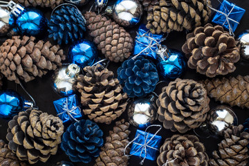 Christmas background with blue silver balls and pinecone.