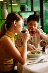 Couple in Chinese restaurant, drinking wine