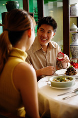 Man proposing to woman at restaurant