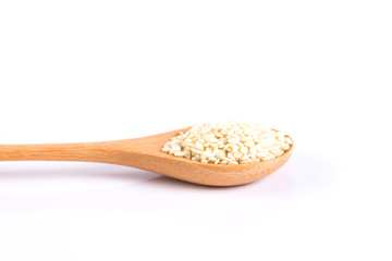 close up white sesame in wooden spoon on white background