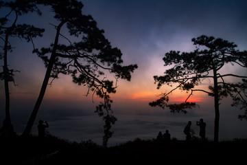 silhouette people sunrise on the mountain.