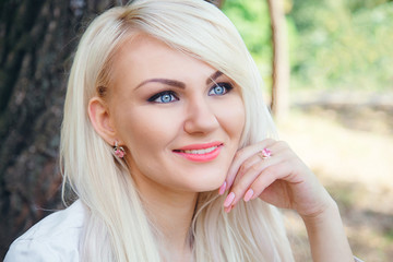 Naklejka premium Face of young woman with beautiful blue eyes close portrait