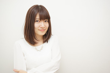 Young woman treating her hair on the white background