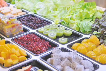 Various vegetables mixed on salad bar.