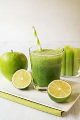 Healthy green celery smoothie in glass