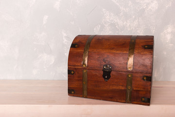 Chest on the wooden floor, against the backdrop of a blue wall
