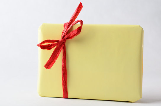 Simple Gift Package In Yellow With Red Raffia Ribbon