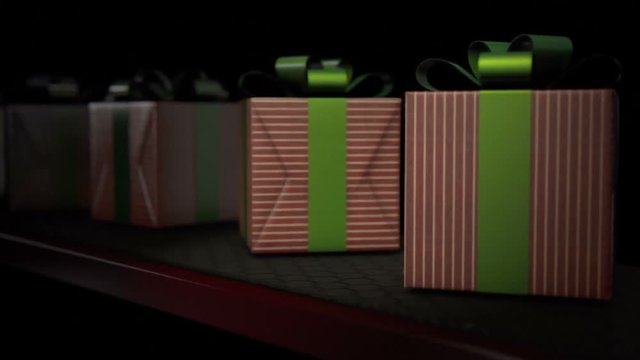 A row of wrapped gift boxes in a shiny red wrapping paper and green ribbon moving slowly on a production line conveyor belt
