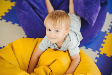 Portrait of a cute little boy playing on playground in kindergar