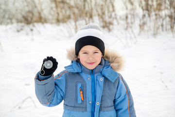 portrait of a boy, the compass shows on the background of the river © vitec40